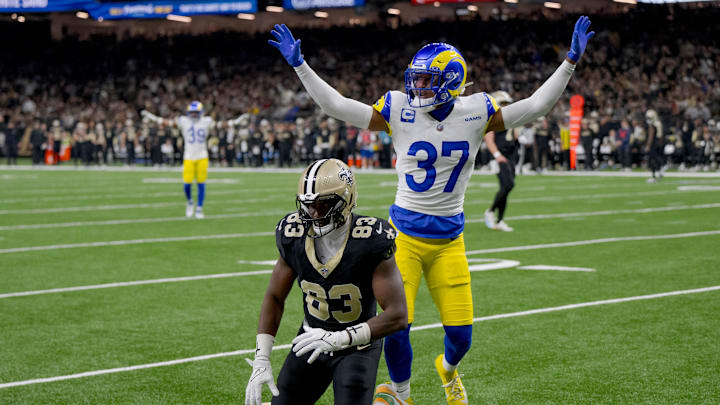 Dec 1, 2024; New Orleans, Louisiana, USA;  New Orleans Saints tight end Juwan Johnson (83) is prevented from making a catch by Los Angeles Rams safety Quentin Lake (37) during the first half at Caesars Superdome. Mandatory Credit: Matthew Hinton-Imagn Images