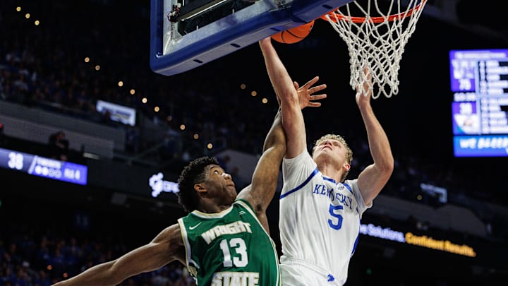 Nov 4, 2024; Lexington, Kentucky, USA; Kentucky Wildcats guard Collin Chandler (5) goes to the basket against Wright State Raiders guard Solomon Callaghan (13) during the second half at Rupp Arena at Central Bank Center. Mandatory Credit: Jordan Prather-Imagn Images