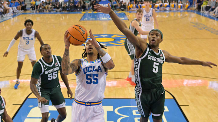 UCLA Bruins guard Skyy Clark (55) drives past Michigan State Spartans guard Tre Holloman. 