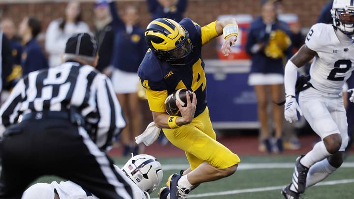 Oct 17, 2026; Ann Arbor, Michigan, USA; Michigan Wolverines quarterback Tommy Carr (14) runs the ball passed Penn State Nittany Lions defensive back Marcus Neal (31) in the second half at Michigan Stadium. Mandatory Credit: Rick Osentoski-Imagn Images Oct 17, 2026; Ann Arbor, Michigan, USA; Michigan Wolverines quarterback Tommy Carr (14) runs the ball passed Penn State Nittany Lions defensive back Marcus Neal (31) in the second half at Michigan Stadium. Mandatory Credit: Rick Osentoski-Imagn Images