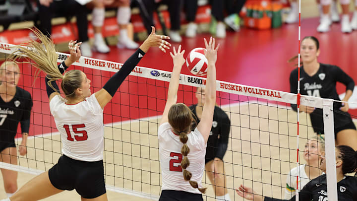 Andi Jackson and Bergen Reilly block a Wright State attack.