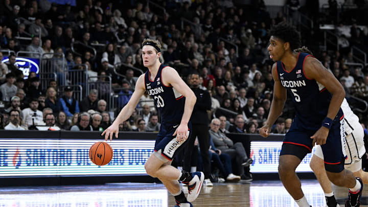 Mar 1, 2025; Providence, Rhode Island, USA; Connecticut Huskies forward Liam McNeeley (30) dribbles to the basket against the Providence Friars during the second half at Amica Mutual Pavilion. Mandatory Credit: Eric Canha-Imagn Images