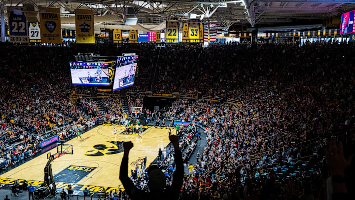 Fans celebrate a 3-pointer by Indiana Fever guard Caitlin Clark (22) on Sunday, May 4, 2025, during a preseason game between the Indiana Fever and the Brazil national team at Carver-Hawkeye Arena in Iowa City. The Indiana Fever defeated the Brazilian National Team, 108-44.
