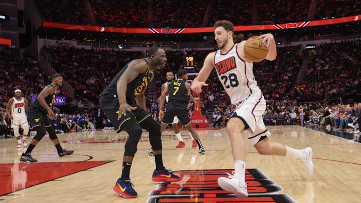 Feb 13, 2025; Houston, Texas, USA; Houston Rockets center Alperen Sengun (28) dribbles against Golden State Warriors forward Draymond Green (23) in the second  half at Toyota Center. Mandatory Credit: Thomas Shea-Imagn Images
