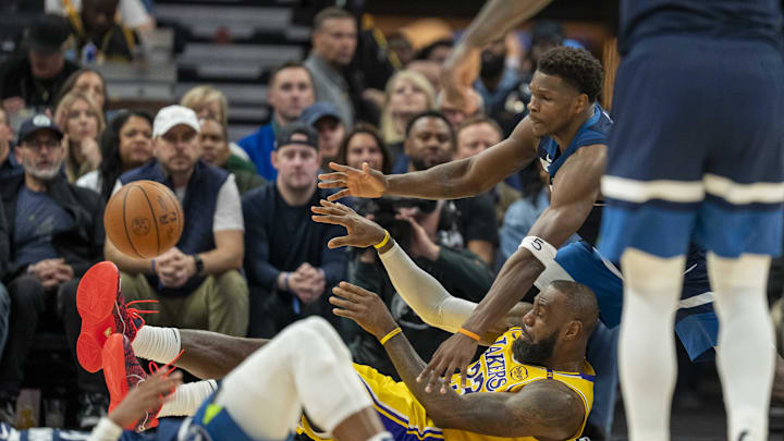 Apr 25, 2025; Minneapolis, Minnesota, USA; Los Angeles Lakers forward LeBron James (23) passes the ball from the ground as Minnesota Timberwolves guard Anthony Edwards (5) pls defense in the first half during game three of first round for the 2024 NBA Playoffs at Target Center. Mandatory Credit: Jesse Johnson-Imagn Images