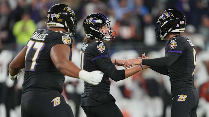 Oct 9, 2022; Baltimore, Maryland, USA; Baltimore Ravens kicker Justin Tucker (right), holder Jordan Stout (center) and tackle Daniel Faalele (left) celebrate the game winning field goal with time expiring against the Cincinnati Bengals at M&T Bank Stadium. Mandatory Credit: Mitch Stringer-Imagn Images