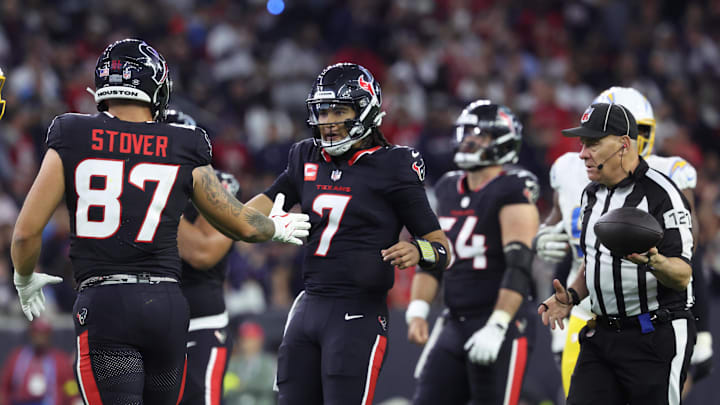 Jan 11, 2025; Houston, Texas, USA; Houston Texans quarterback C.J. Stroud (7) celebrates with tight end Cade Stover (87) after a play during the third quarter against the Los Angeles Chargers in an AFC wild card game at NRG Stadium. Mandatory Credit: Troy Taormina-Imagn Images