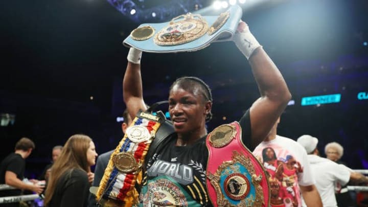 Claressa Shields and trainers pose with the WBC Elizabethan Belt and IBF, WBA, WBC, WBO World Middleweight Title belts after victory. She called out on Jake Paul for match Claressa Shields and trainers pose with the WBC Elizabethan Belt and IBF, WBA, WBC, WBO World Middleweight Title belts after victory. She called out on Jake Paul for match