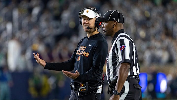 Oct 18, 2025; South Bend, Indiana, USA; Southern California Trojans head coach Lincoln Riley talks to an official during the first half against the Notre Dame Fighting Irish at Notre Dame Stadium. Mandatory Credit: Michael Caterina-Imagn Images