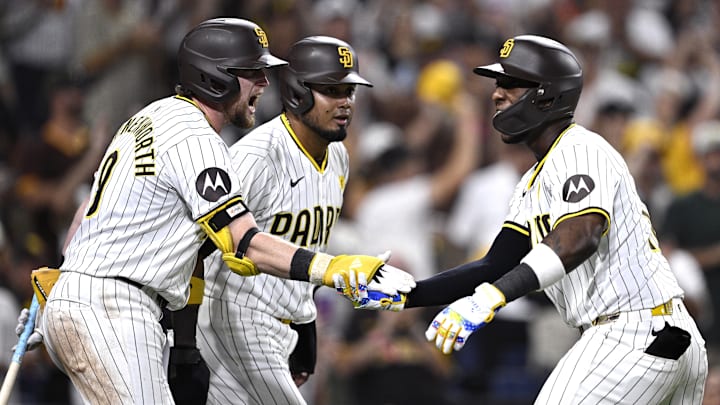 Aug 20, 2024; San Diego, California, USA; San Diego Padres left fielder Jurickson Profar (right) celebrates with first baseman Jake Cronenworth (9) and designated hitter Luis Arraez (center) after hitting a three-run home run against the Minnesota Twins during the eighth inning at Petco Park. Mandatory Credit: Orlando Ramirez-Imagn Images