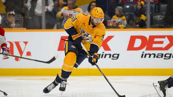 Apr 6, 2025; Nashville, Tennessee, USA;  Nashville Predators left wing Michael Bunting skates with the puck against the Montreal Canadiens during the first period at Bridgestone Arena. Mandatory Credit: Steve Roberts-Imagn Images