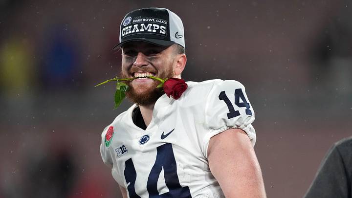 Jan 2, 2023; Pasadena, California, USA; Penn State Nittany Lions quarterback Sean Clifford (14) celebrates on the podium after the Penn State Nittany Lions defeated the Utah Utes in the 109th Rose Bowl game at the Rose Bowl. Mandatory Credit: Kirby Lee-Imagn Images