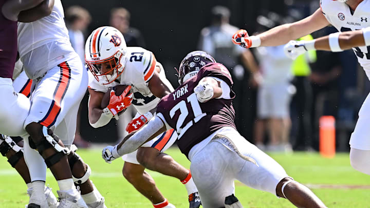 Sep 23, 2023; College Station, Texas, USA; Texas A&M Aggies linebacker Taurean York (21) tackles Auburn Tigers running back Brian Battie (21) during the second quarter at Kyle Field. Mandatory Credit: Maria Lysaker-USA TODAY Sports