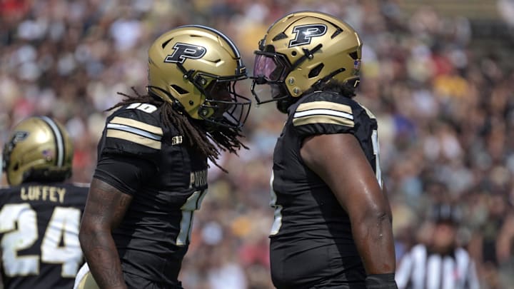Purdue Boilermakers linebacker Alex Sanford Jr. (10) and defensive lineman Demeco Kennedy (18) celebrate 
