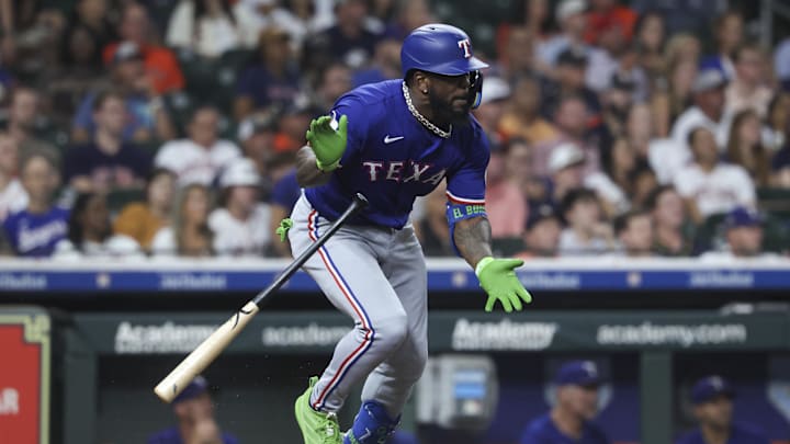 Texas Rangers pinch hitter Adolis Garcia hits an RBI single during the eighth inning against the Houston Astros at Daikin Park. 