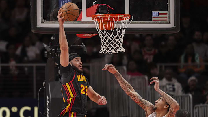 Dec 28, 2024; Atlanta, Georgia, USA; Atlanta Hawks forward Larry Nance Jr. (22) scores a basket over Miami Heat center Kel'el Ware (7) at State Farm Arena. Mandatory Credit: Dale Zanine-Imagn Images