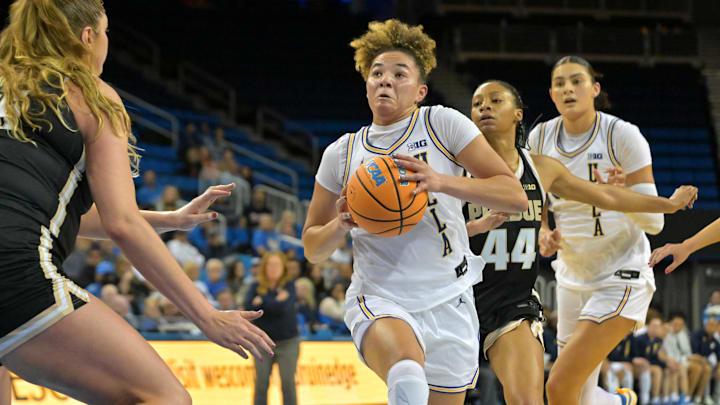 Jan 21, 2026; Los Angeles, California, USA;  Purdue Boilermakers forward Avery Gordon (55) defends UCLA Bruins guard Kiki Rice (1) as she drives past Purdue Boilermakers guard Tara Daye (44) in the first half at Pauley Pavilion presented by Wescom Financial. Mandatory Credit: Jayne Kamin-Oncea-Imagn Images