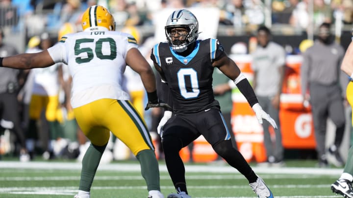Dec 24, 2023; Charlotte, North Carolina, USA; Carolina Panthers linebacker Brian Burns (0) on the edge against Green Bay Packers guard Zach Tom (50) during the second quarter at Bank of America Stadium.  