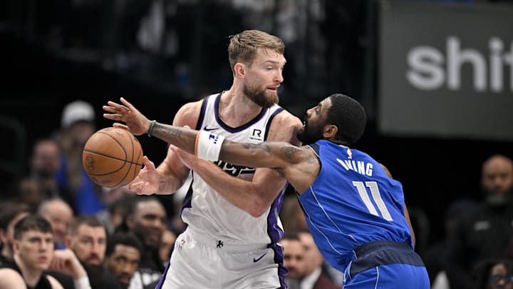 Feb 10, 2025; Dallas, Texas, USA; Dallas Mavericks guard Kyrie Irving (11) knocks the ball away from Sacramento Kings forward Domantas Sabonis (11) during the first quarter at the American Airlines Center. Mandatory Credit: Jerome Miron-Imagn Images