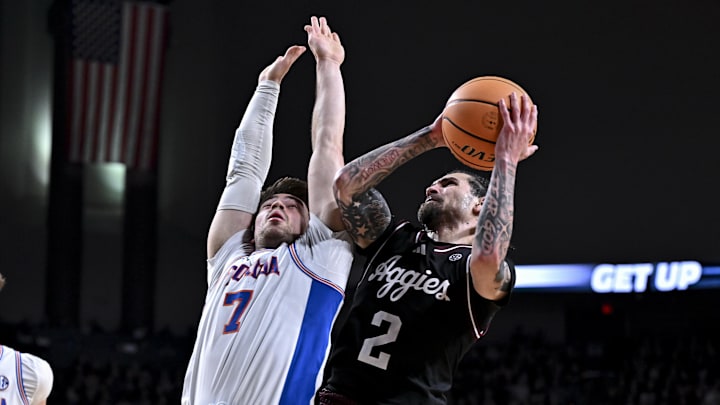 Feb 7, 2026; College Station, Texas, USA; Texas A&M Aggies guard Pop Isaacs (2) goes to the basket as Florida Gators guard Urban Klavzar (7) defends during the second half at Reed Arena. Mandatory Credit: Maria Lysaker-Imagn Images 