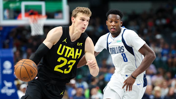 Oct 10, 2024; Dallas, Texas, USA;  Utah Jazz forward Lauri Markkanen (23) drives to the basket as Dallas Mavericks forward Olivier-Maxence Prosper (8) defends during the second half at American Airlines Center. Mandatory Credit: Kevin Jairaj-Imagn Images