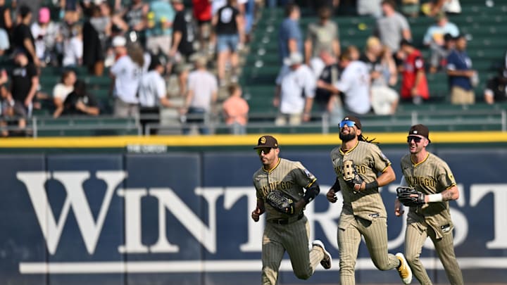 Sep 21, 2025; Chicago, Illinois, USA; San Diego Padres left fielder Ramon Laureano (5), center fielder Jackson Merrill (3), and right fielder Fernando Tatis Jr. (23) celebrate after defeating the Chicago White Sox at Rate Field. Mandatory Credit: Patrick Gorski-Imagn Images Sep 21, 2025; Chicago, Illinois, USA; San Diego Padres left fielder Ramon Laureano (5), center fielder Jackson Merrill (3), and right fielder Fernando Tatis Jr. (23) celebrate after defeating the Chicago White Sox at Rate Field. Mandatory Credit: Patrick Gorski-Imagn Images