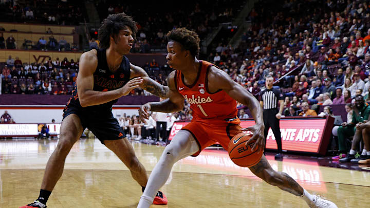 Jan 4, 2025; Blacksburg, Virginia, USA; Virginia Tech Hokies forward Tobi Lawal (1) drives to the basket against Miami Hurricanes forward Isaiah Johnson-Arigu (4) during the first half at Cassell Coliseum. Mandatory Credit: Peter Casey-Imagn Images Jan 4, 2025; Blacksburg, Virginia, USA; Virginia Tech Hokies forward Tobi Lawal (1) drives to the basket against Miami Hurricanes forward Isaiah Johnson-Arigu (4) during the first half at Cassell Coliseum. Mandatory Credit: Peter Casey-Imagn Images
