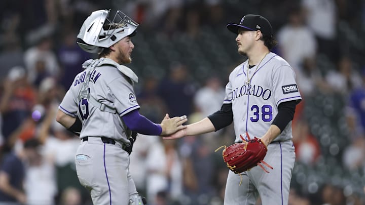 Colorado Rockies catcher Hunter Goodman (15) and pitcher Victor Vodnik (38) 