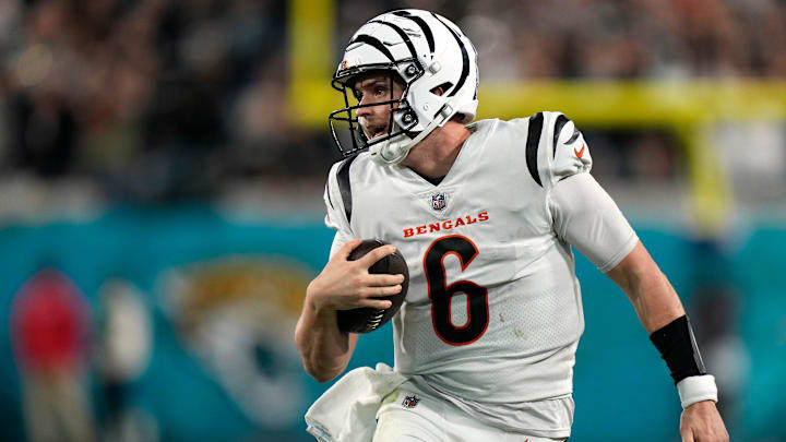 Cincinnati Bengals quarterback Jake Browning (6) carries the ball for a first down in the fourth