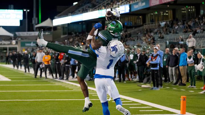 Nov 28, 2024; New Orleans, Louisiana, USA; Tulane Green Wave wide receiver Shazz Preston (6) scores a touchdown against Memphis Tigers defensive back Davion Ross (1) during the fourth quarter at Yulman Stadium. Mandatory Credit: Matthew Hinton-Imagn Images Nov 28, 2024; New Orleans, Louisiana, USA; Tulane Green Wave wide receiver Shazz Preston (6) scores a touchdown against Memphis Tigers defensive back Davion Ross (1) during the fourth quarter at Yulman Stadium. Mandatory Credit: Matthew Hinton-Imagn Images