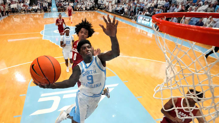 Dec 4, 2024; Chapel Hill, North Carolina, USA; North Carolina Tar Heels guard Drake Powell (9) shoots as Alabama Crimson Tide guard Labaron Philon (0) defends in the second half at Dean E. Smith Center. Mandatory Credit: Bob Donnan-Imagn Images