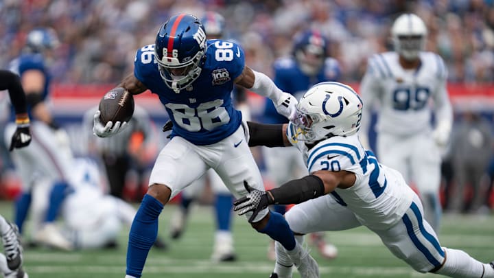 New York Giants wide receiver Darius Slayton (86) breaks a tackle by Indianapolis Colts defensive back Nick Cross (20) during a game between New York Giants and Indianapolis Colts at MetLife Stadium on Sunday, Dec. 29, 2024.
