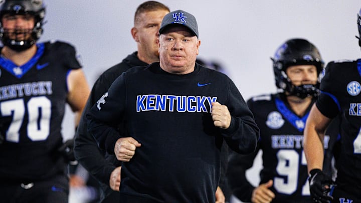Oct 25, 2025; Lexington, Kentucky, USA; Kentucky Wildcats head coach Mark Stoops runs onto the field before the game against the Tennessee Volunteers at Kroger Field. Mandatory Credit: Jordan Prather-Imagn Images