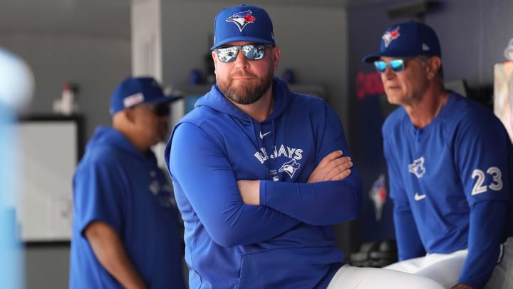 Toronto Blue Jays manager John Schneider (14) looks out from the dugout prior to the start of a game against the Cleveland Guardians at Rogers Centre on June 15. Toronto Blue Jays manager John Schneider (14) looks out from the dugout prior to the start of a game against the Cleveland Guardians at Rogers Centre on June 15.