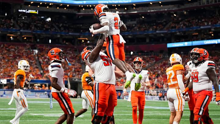 Syracuse offensive lineman Da'Metrius Weatherspoon lifts Syracuse wide receiver Johntay Cook in celebration after a touchdown during the Aflac Kickoff Game between the Volunteers and Syracuse Syracuse offensive lineman Da'Metrius Weatherspoon lifts Syracuse wide receiver Johntay Cook in celebration after a touchdown during the Aflac Kickoff Game between the Volunteers and Syracuse
