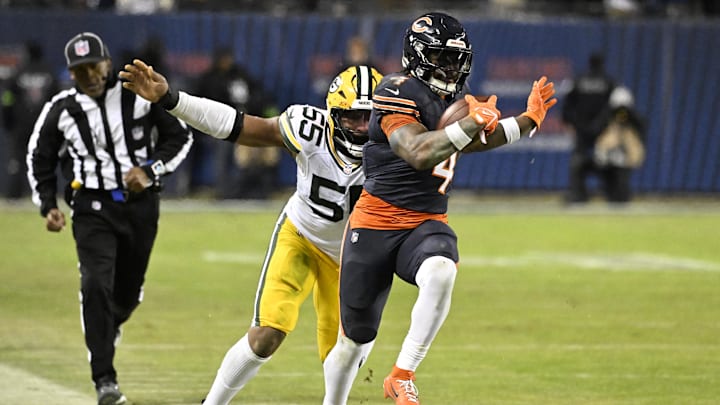 Jan 10, 2026; Chicago, IL, USA;  Chicago Bears running back D'Andre Swift (4) runs runs after the catch as Green Bay Packers defensive end Kingsley Enagbare (55) defends during the second half of an NFC Wild Card Round game at Soldier Field. Mandatory Credit: Matt Marton-Imagn Images