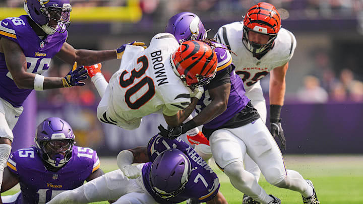 Sep 21, 2025; Minneapolis, Minnesota, USA; Cincinnati Bengals running back Chase Brown (30) is tackled during the first half against the Minnesota Vikings at U.S. Bank Stadium. Mandatory Credit: Brad Rempel-Imagn Images