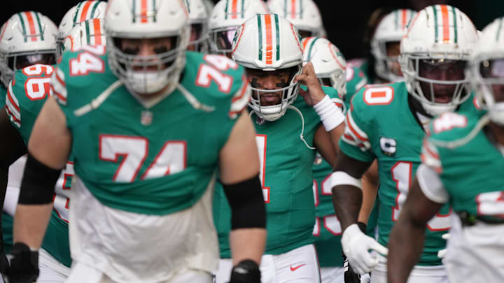 Miami Dolphins quarterback Tua Tagovailoa (1) puts his helmet on before heading out to warm-up before the NFL game against the Dallas Cowboys at Hard Rock Stadium in Miami Gardens, Dec. 24, 2023. Miami Dolphins quarterback Tua Tagovailoa (1) puts his helmet on before heading out to warm-up before the NFL game against the Dallas Cowboys at Hard Rock Stadium in Miami Gardens, Dec. 24, 2023.
