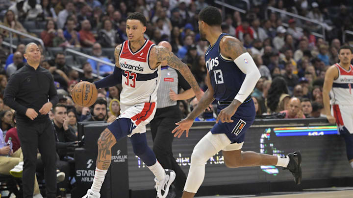Mar 1, 2024; Los Angeles, California, USA;  Washington Wizards forward Kyle Kuzma (33) is defended by Los Angeles Clippers forward Paul George (13) in the second half at Crypto.com Arena. Mandatory Credit: Jayne Kamin-Oncea-Imagn Images