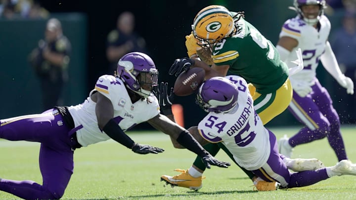 Minnesota Vikings linebacker Kamu Grugier-Hill intercepts a pass intended for Green Bay Packers receiver Christian Watson.