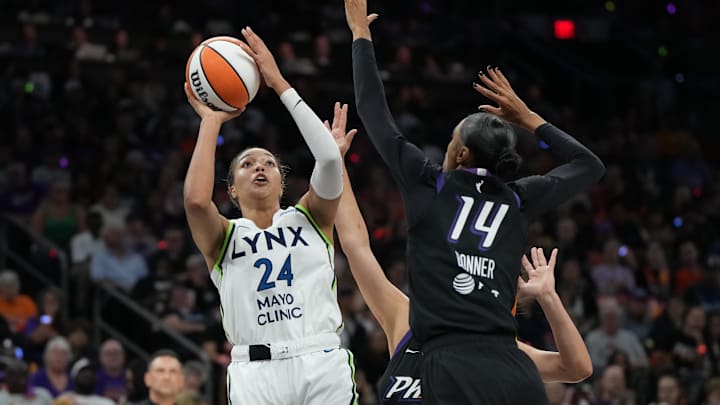 Sep 26, 2025; Phoenix, Arizona, USA; Minnesota Lynx forward Napheesa Collier (24) shoots over Phoenix Mercury forward DeWanna Bonner (14) during game three of the second round for the 2025 WNBA Playoffs at PHX Arena. Mandatory Credit: Rick Scuteri-Imagn Images