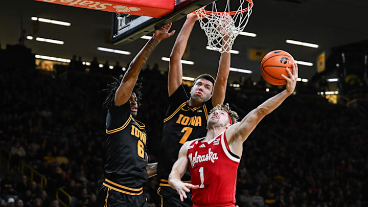 Feb 17, 2026; Iowa City, Iowa, USA; Nebraska Cornhuskers guard Sam Hoiberg (1) goes to the basket as Iowa Hawkeyes forward Alvaro Folgueiras (rear) and guard Tavion Banks (6) defend during the first half at Carver-Hawkeye Arena. Mandatory Credit: Jeffrey Becker-Imagn Images