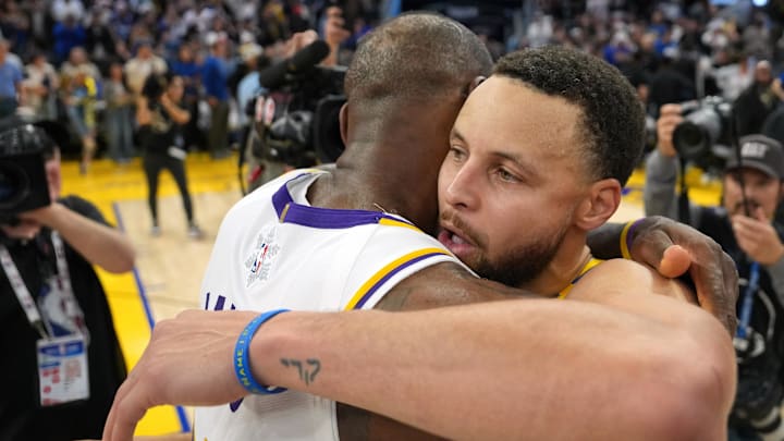 Dec 25, 2024; San Francisco, California, USA; Golden State Warriors guard Stephen Curry (center right) greets Los Angeles Lakers forward LeBron James (center left) after the game at Chase Center. Mandatory Credit: Darren Yamashita-Imagn Images