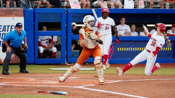 Texas catcher Reese Atwood (14) gets a force out at home as Texas Tech Hailey Toney (32) approaches in Game 2 of the Women's College World Series championship series between the Texas Longhorns at Texas Tech Red Raiders at Devon Park in Oklahoma City, Thursday, June 5, 2025. Texas Tech won 4-3.