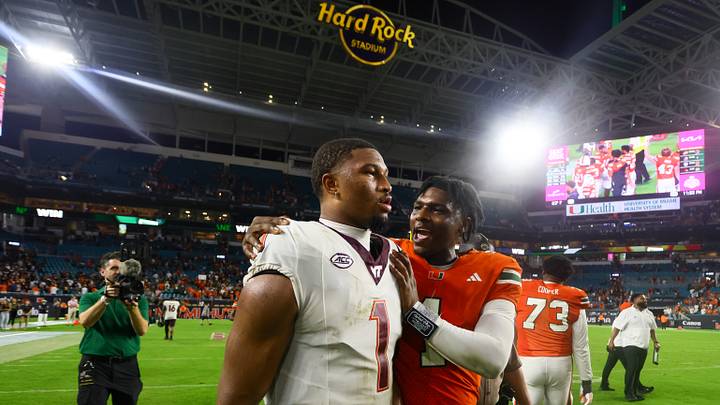 Sep 27, 2024; Miami Gardens, Florida, USA; Miami Hurricanes quarterback Cam Ward (1) and Virginia Tech Hokies quarterback Kyron Drones (1) talk on the field after the game at Hard Rock Stadium. Mandatory Credit: Sam Navarro-Imagn Images