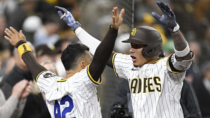 San Diego Padres third baseman Manny Machado (13), right, is congratulated by Jose Iglesias (7) after hitting a solo home run during the fifth inning against the Chicago Cubs at Petco Park. 