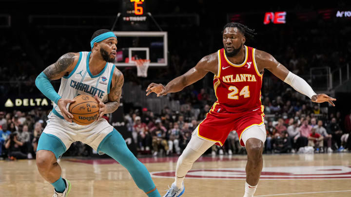 Apr 10, 2024; Atlanta, Georgia, USA; Charlotte Hornets forward Miles Bridges (0) steps back to shoot against Atlanta Hawks forward Bruno Fernando (24) during the second half at State Farm Arena. Mandatory Credit: Dale Zanine-USA TODAY Sports