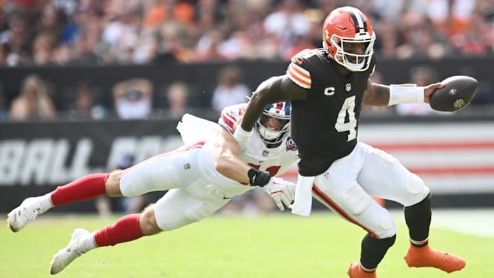 Sep 22, 2024; Cleveland, Ohio, USA; Cleveland Browns quarterback Deshaun Watson (4) scrambles from New York Giants linebacker Micah McFadden (41) during the second half at Huntington Bank Field. Mandatory Credit: Ken Blaze-Imagn Images