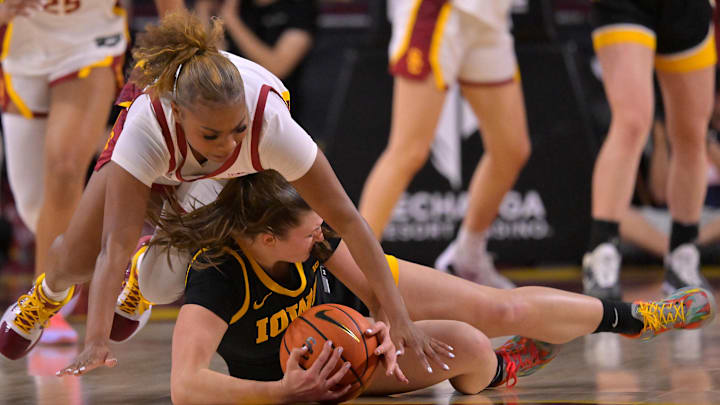 Jan 29, 2026; Los Angeles, California, USA;  USC Trojans guard Londynn Jones (3) and Iowa Hawkeyes guard Taylor Stremlow (1) battle for a loose ball in the first half at Galen Center. Mandatory Credit: Jayne Kamin-Oncea-Imagn Images