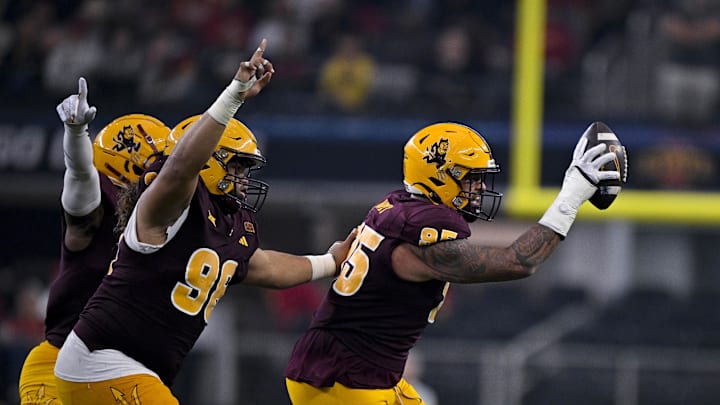 Dec 7, 2024; Arlington, TX, USA; Arizona State Sun Devils defensive lineman Anthonie Cooper (96) and defensive lineman Justin Wodtly (95) celebrate after Wodtly recovers a Iowa State Cyclones fumble during the second half at AT&T Stadium. Mandatory Credit: Jerome Miron-Imagn Images